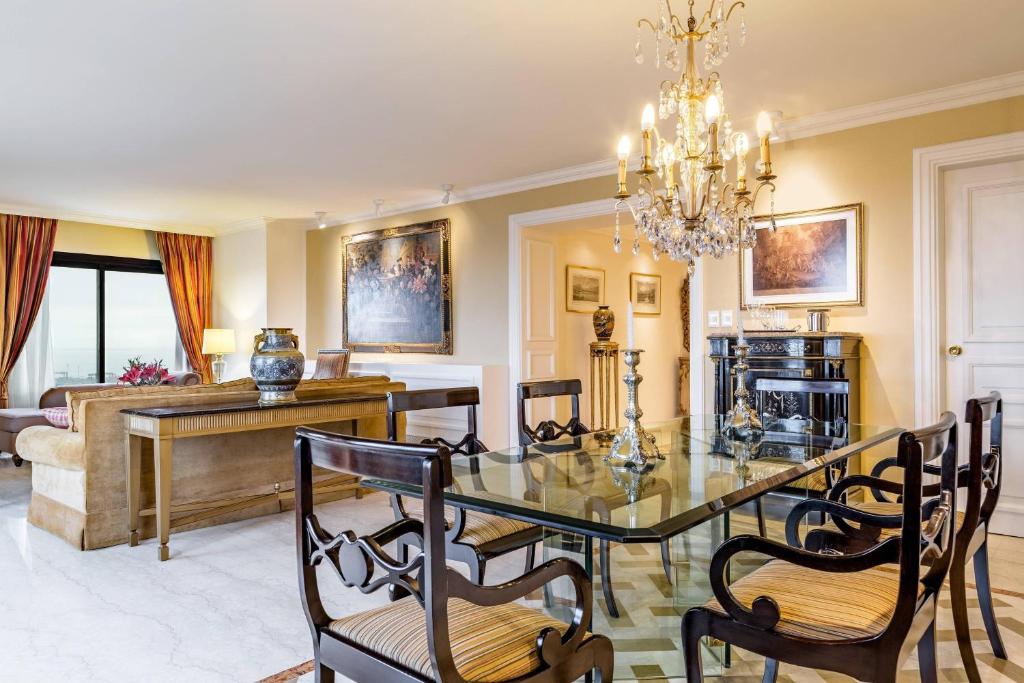 a dining room and living room with a table and chairs at Sheraton Buenos Aires Hotel & Convention Center in Buenos Aires