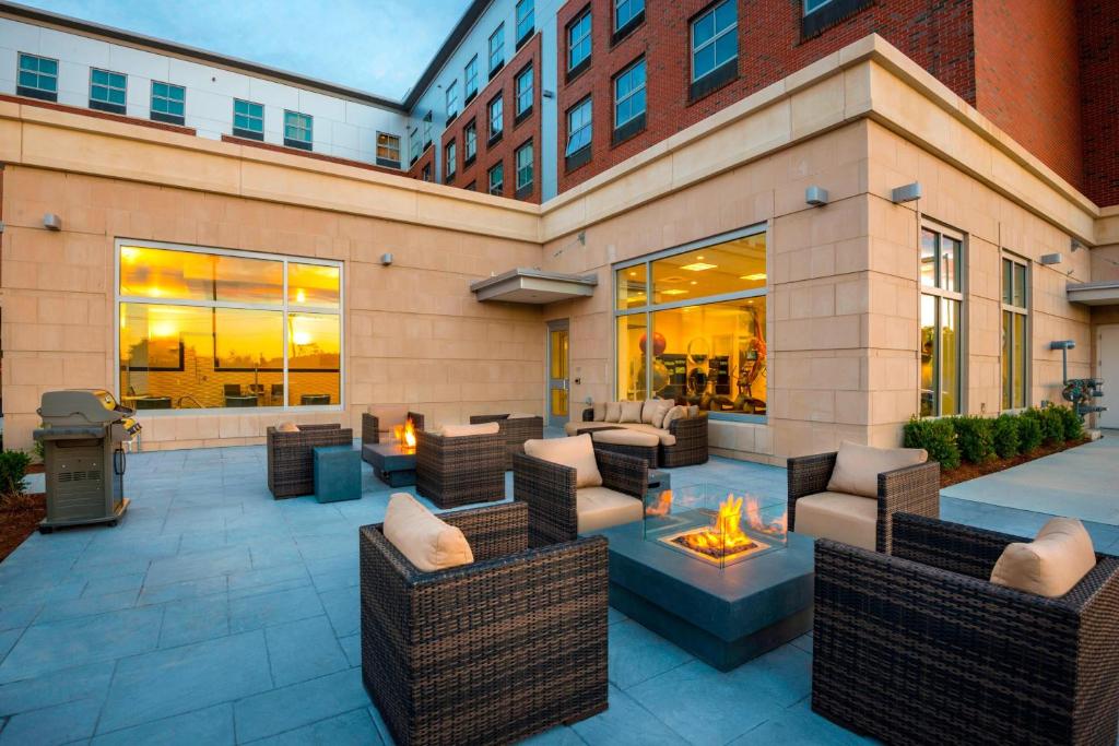 a patio with couches and a fire pit at Residence Inn by Marriott Boston Needham in Needham