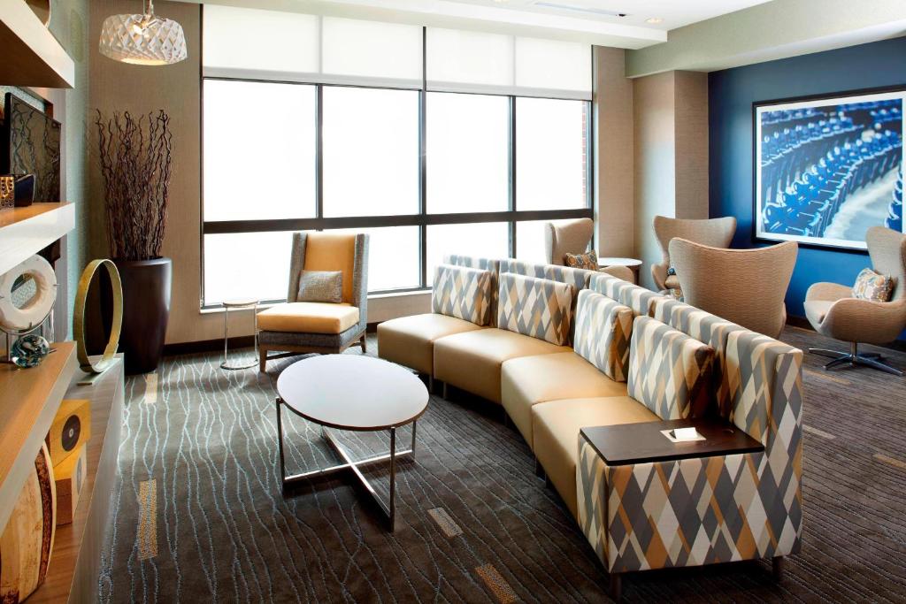 a living room with a couch and a tv at Courtyard by Marriott Akron Downtown in Akron