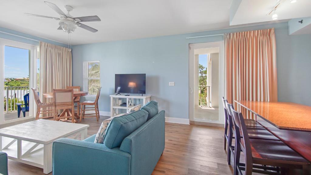a living room with a couch and a dining room at Laketown Wharf #101 by Nautical Properties Vacation Rentals in Panama City Beach