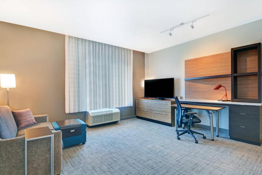 a hotel room with a desk and a television at TownePlace Suites by Marriott Jackson Airport/Flowood in Flowood