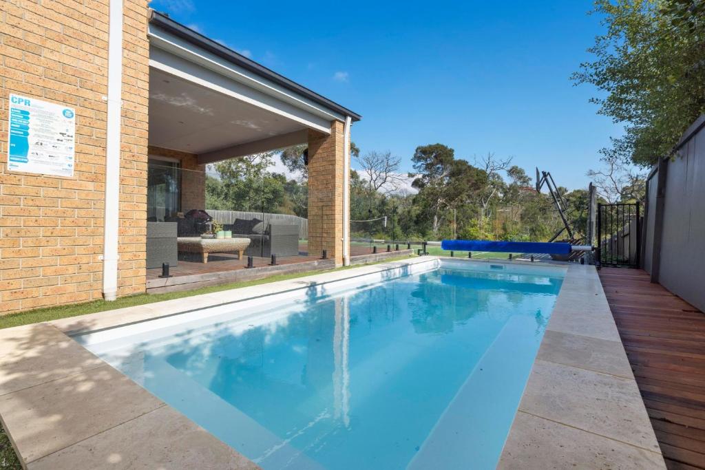 a swimming pool in the backyard of a house at Corymbia Mount Martha in Mount Martha