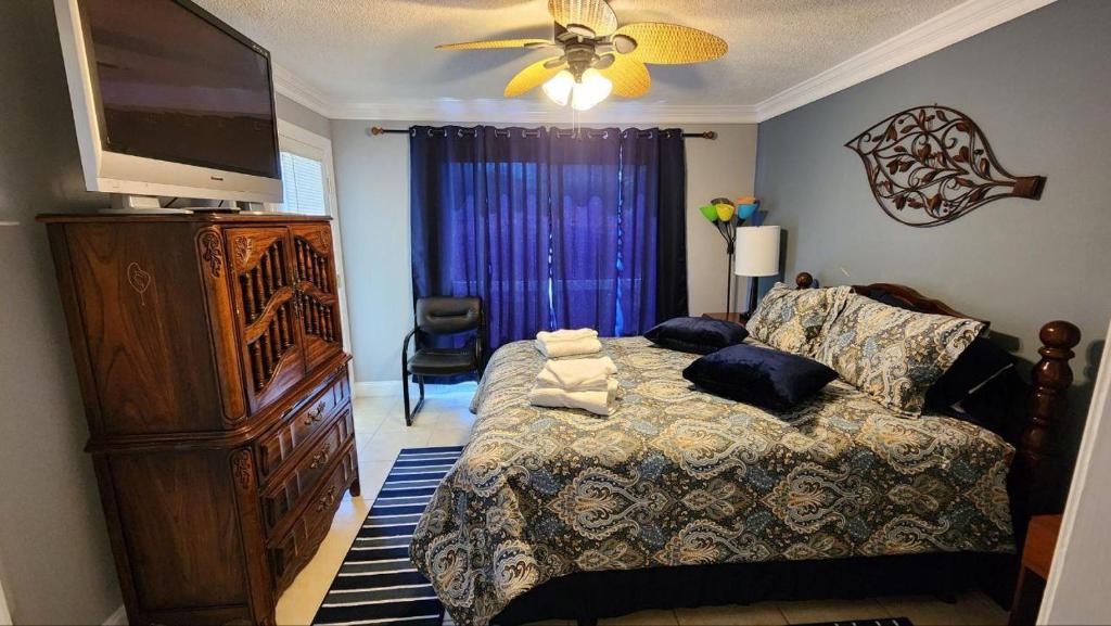 a bedroom with a bed and a flat screen tv at Unique 2 Bedroom / 2 Bath Condo in Myrtle Beach in Myrtle Beach