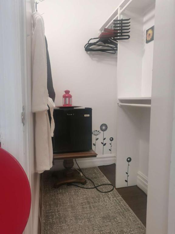 a room with a closet with a television in it at Cozy House B&B in Niagara Falls