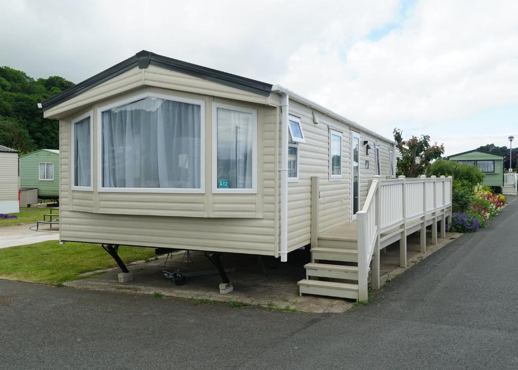 a mobile home sitting on the side of a road at Silver Birch Caravan Park in Talacre