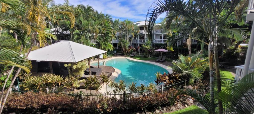 an aerial view of a resort pool with palm trees at South Pacific Resort & Spa Noosa in Noosaville