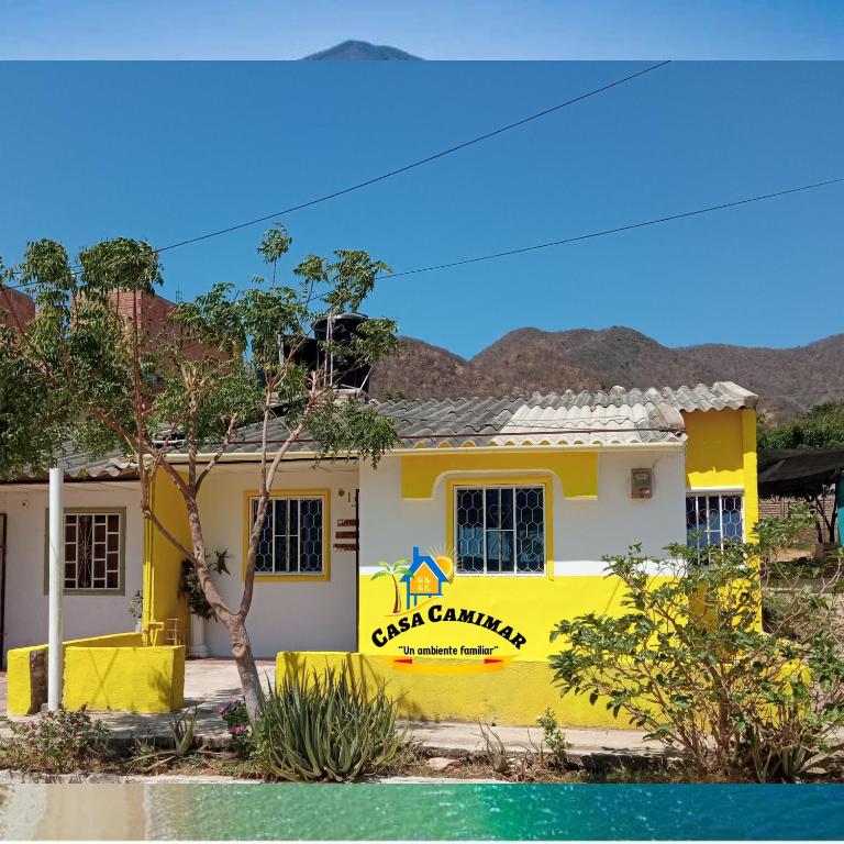 a yellow house with a yellow sign on it at Casa CamiMar, Casa Amoblada solo para tí y tú familia in Santa Marta
