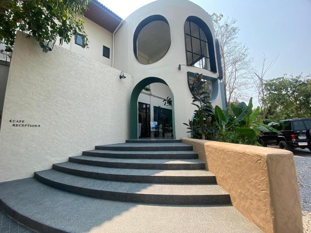 um edifício com escadas em frente a um edifício em Family Room by 233Poshtel em Lampang