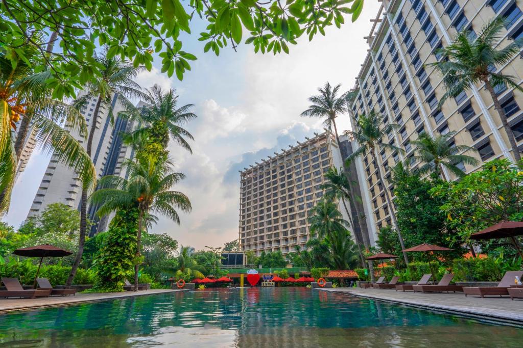 a swimming pool in front of two tall buildings at The Sultan Hotel & Residence Jakarta in Jakarta