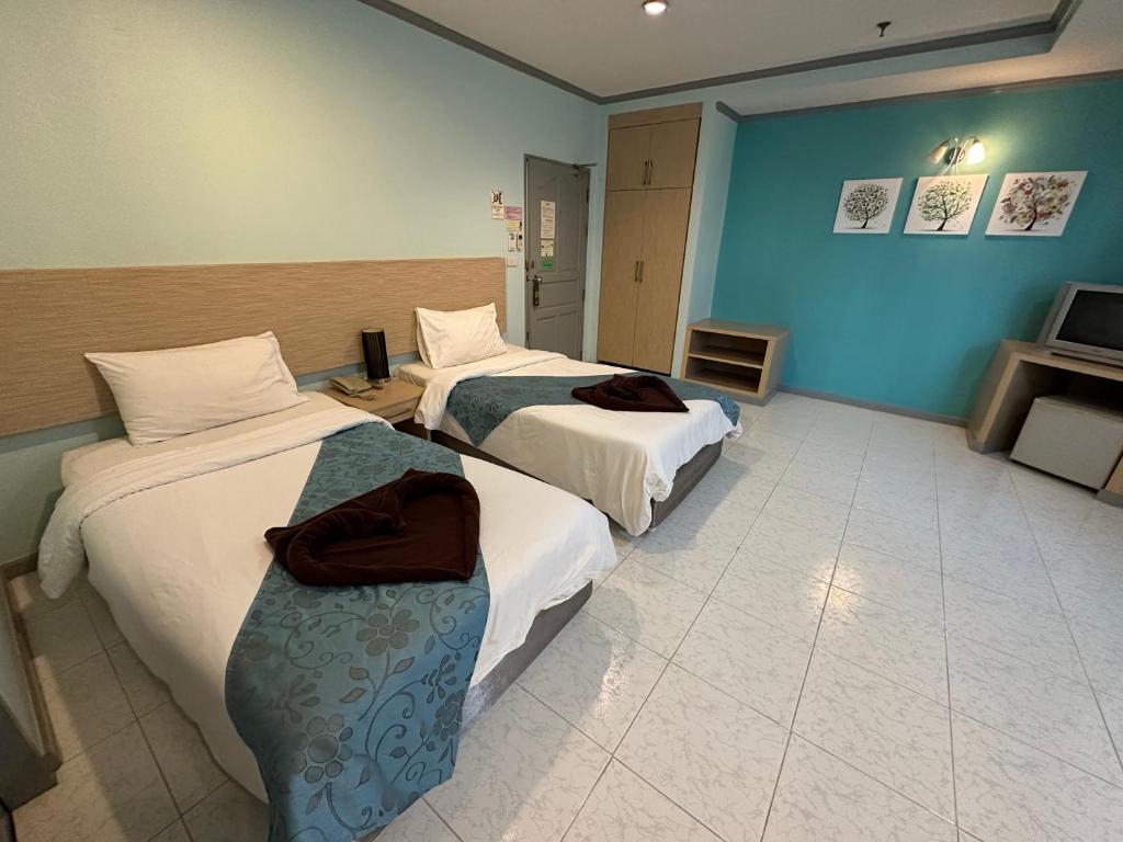 Postel nebo postele na pokoji v ubytování Thipurai City Hotel