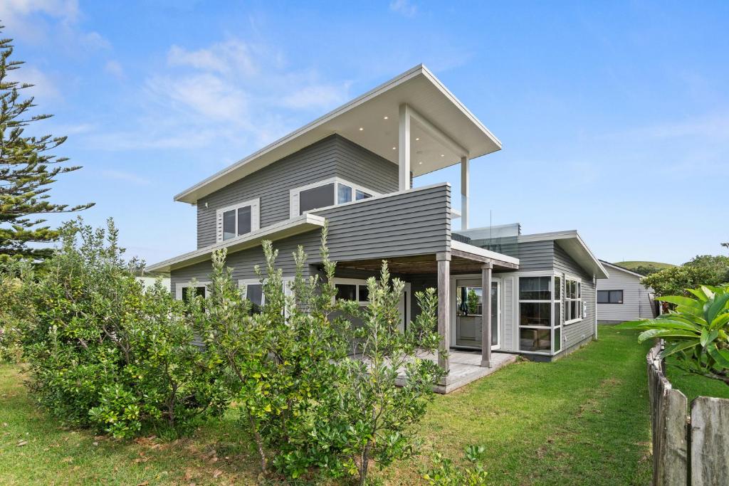 a house with a view of the yard at Matapouri Family Retreat - Matapouri Holiday Home in Matapouri