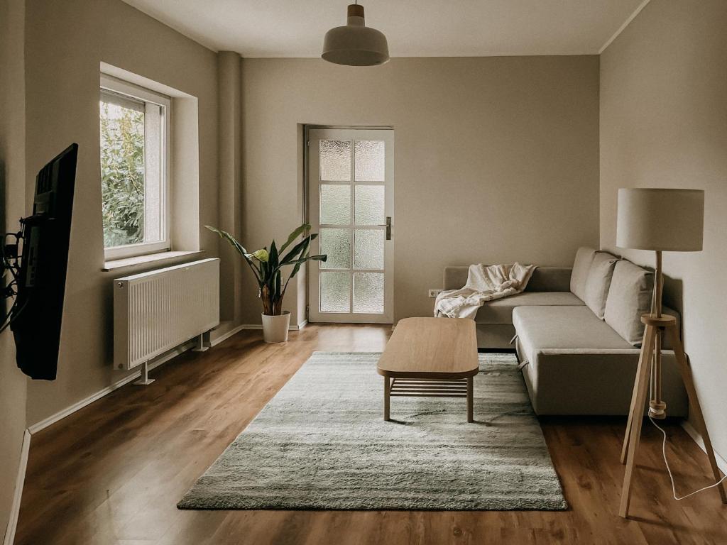 a living room with a couch and a table at Gemütliche 93m² Wohlfühlfläche mit Ausblick zum Weltkulturerbe! in Essen