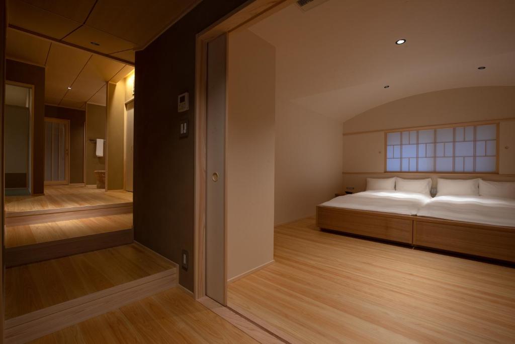 a bedroom with a bed and a large window at Tsukihitei in Nara