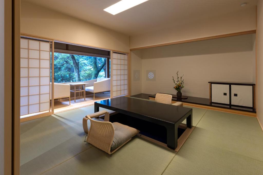 a living room with a table and chairs at Tsukihitei in Nara
