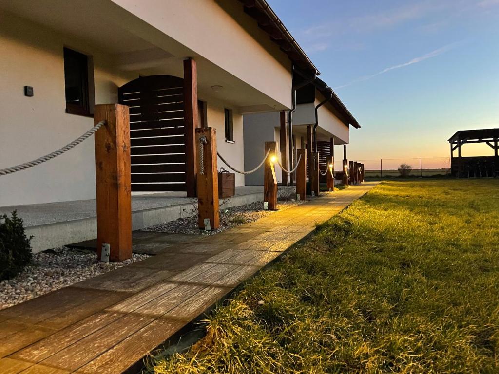 a building with a pathway next to a grass field at Pod Gwiazdami in Władysławowo