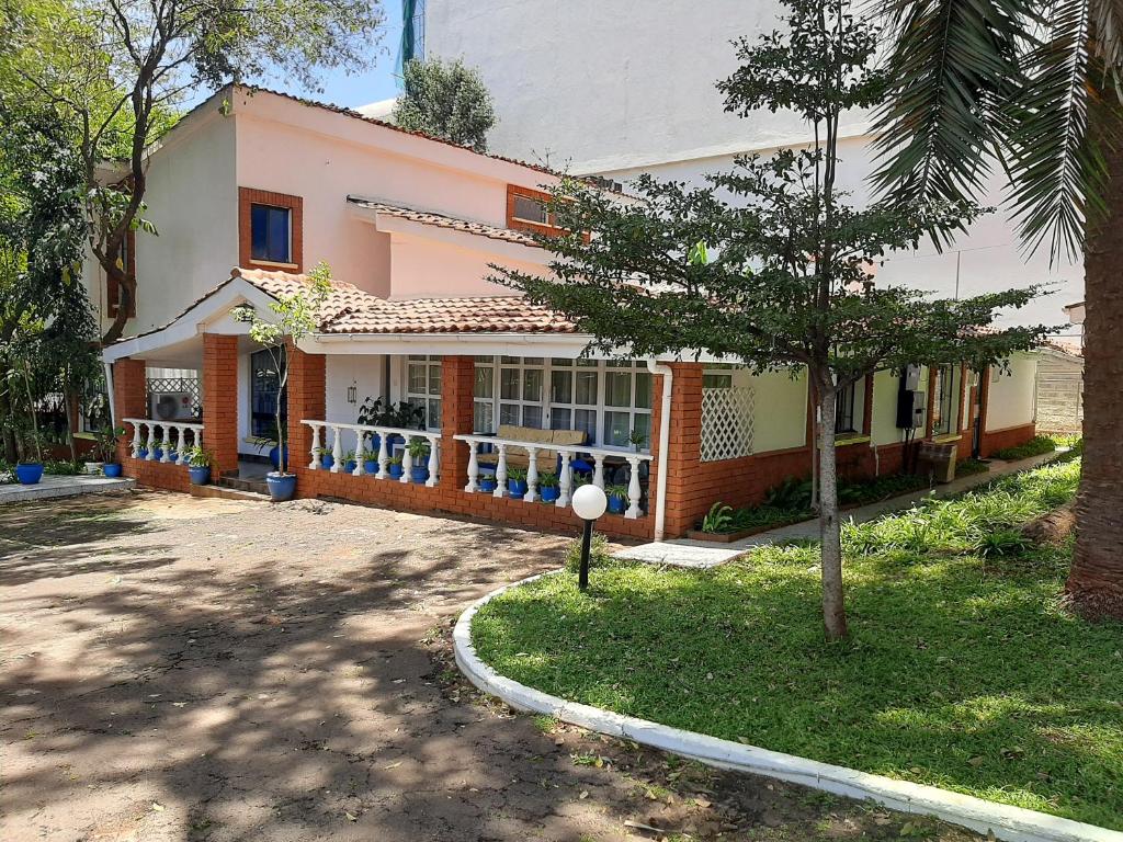 a house with a tree in front of it at Pallicos in Nairobi