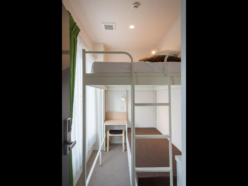 Postel nebo postele na pokoji v ubytování Hotel Plus Hostel SAPPORO