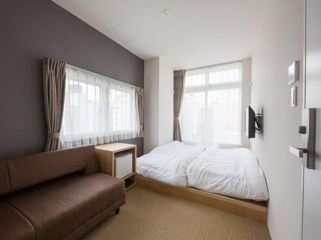 Postel nebo postele na pokoji v ubytování Hotel Plus Hostel SAPPORO