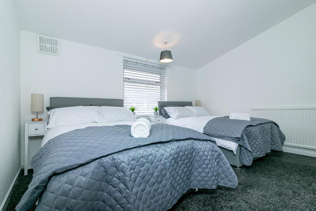 a bedroom with two beds and a window at Fairlands lodge in Stevenage