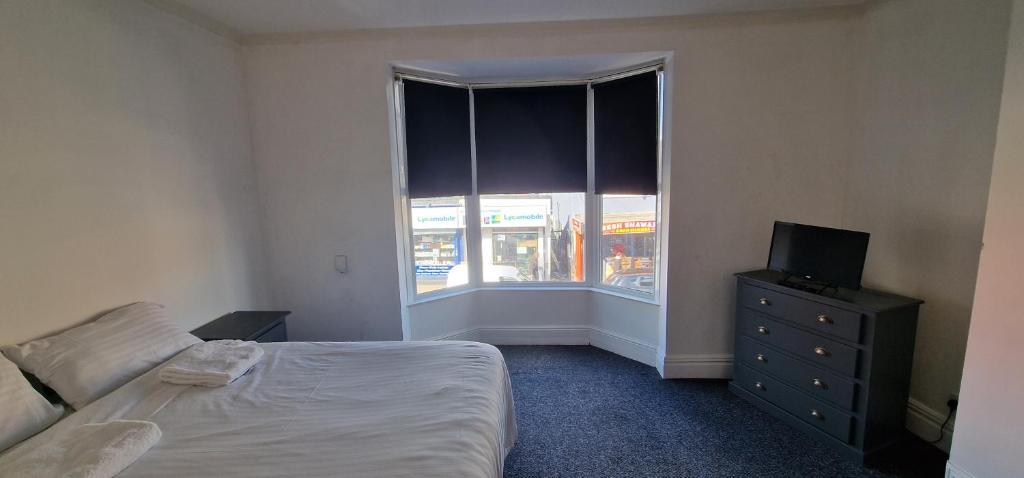 a bedroom with a bed and a television and a window at APARTMENT in CENTRAL DONCASTER in Doncaster
