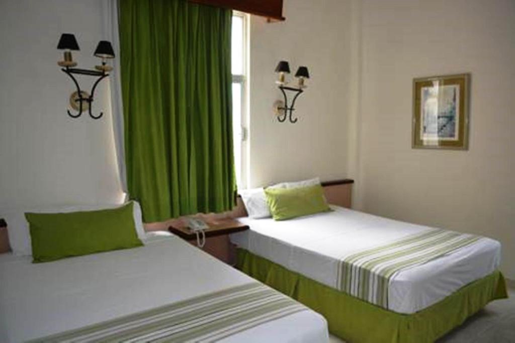 Postel nebo postele na pokoji v ubytování Hotel Ruiz Milán