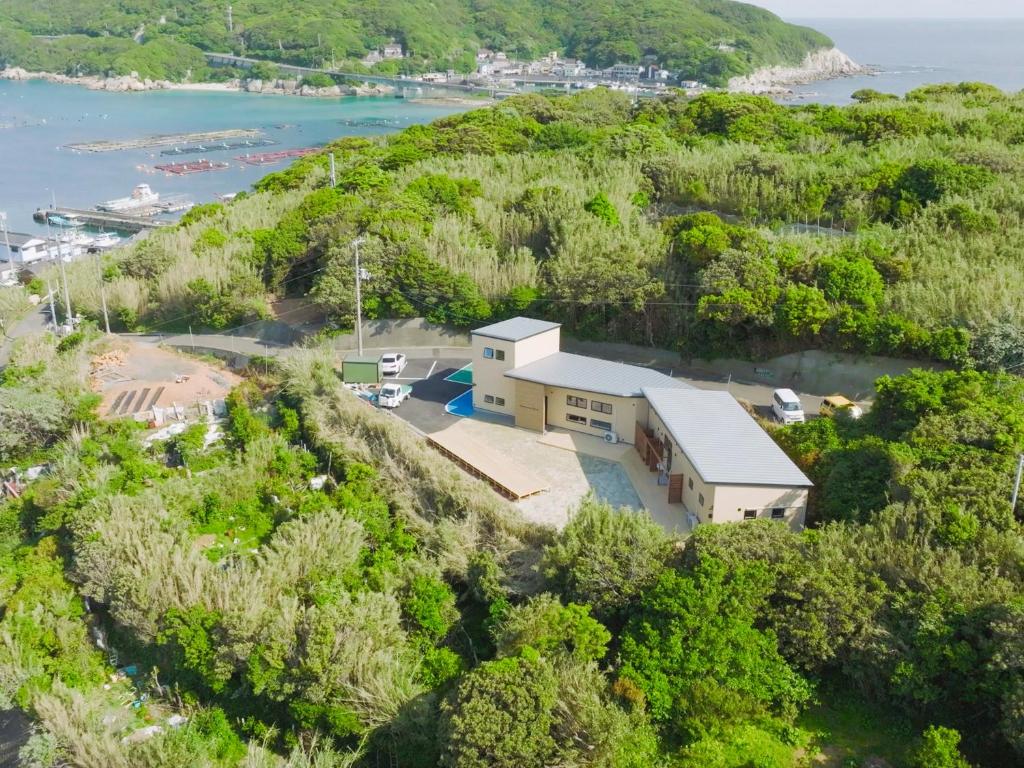 an aerial view of a house on a hill at 柏島ヴィレッジ Kashiwajima Village in Otsuki