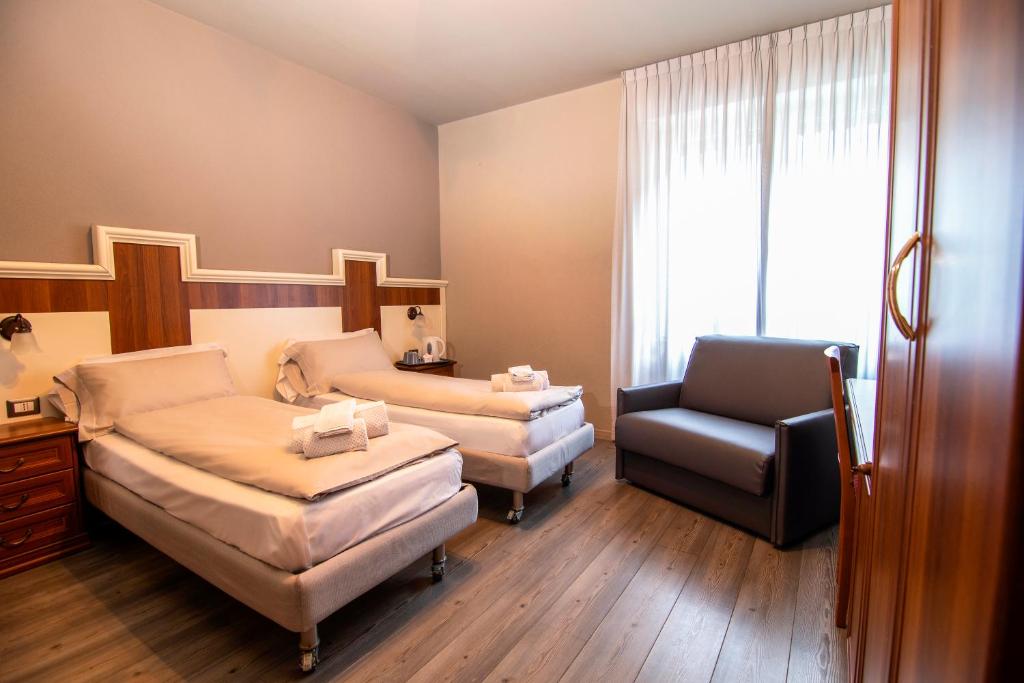 Postel nebo postele na pokoji v ubytování Hotel Saligari