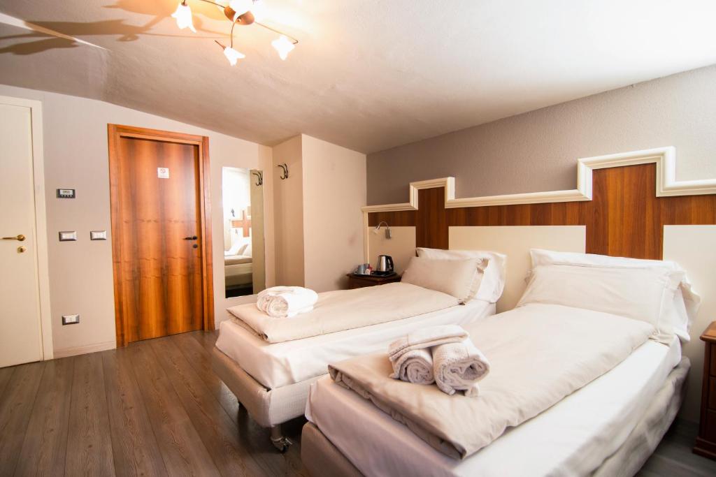 Postel nebo postele na pokoji v ubytování Hotel Saligari