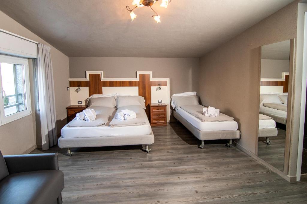Postel nebo postele na pokoji v ubytování Hotel Saligari