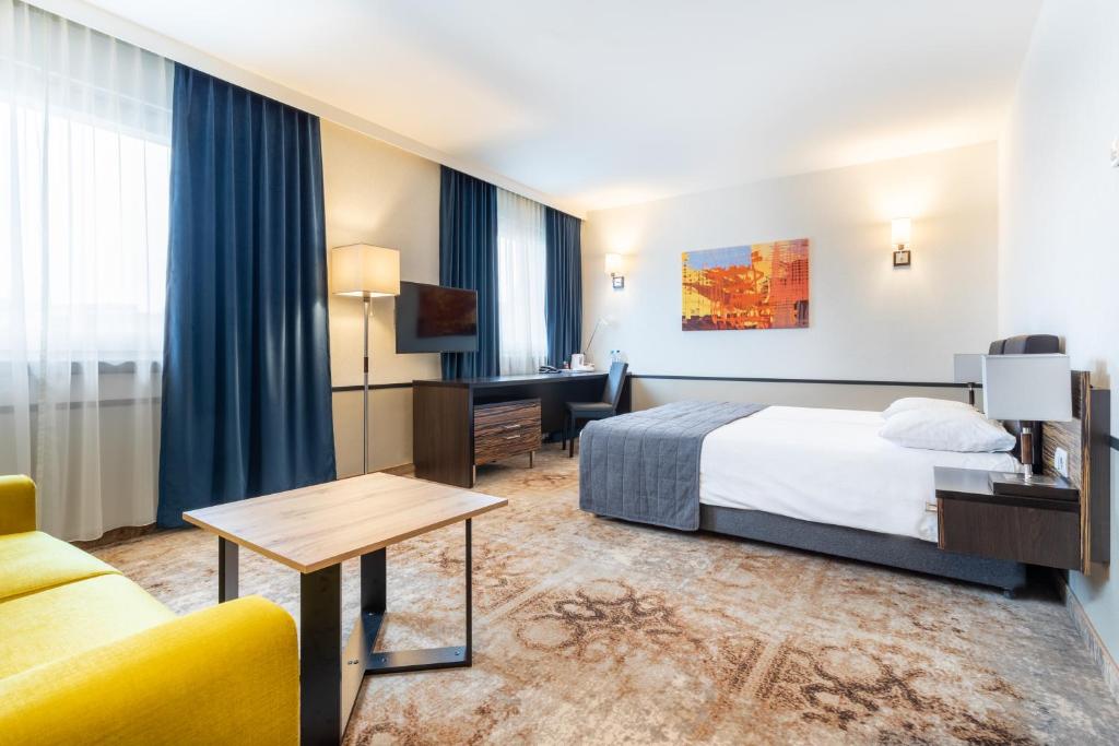 Postel nebo postele na pokoji v ubytování Qubus Hotel Kielce