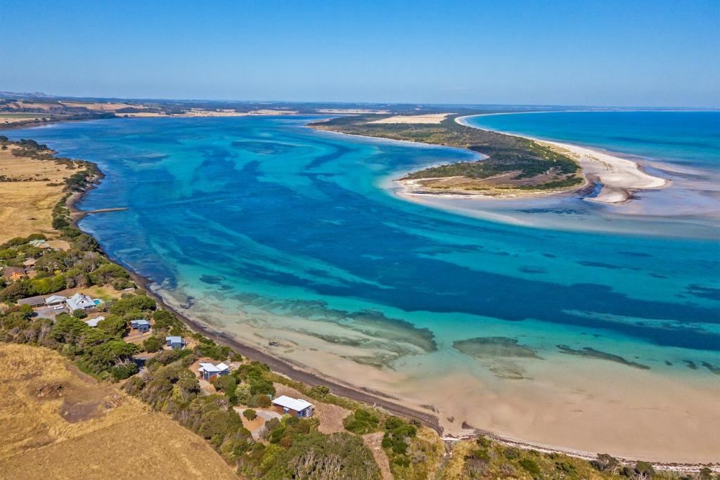 an aerial view of a beach and the ocean at The Inlet Stanley in Stanley