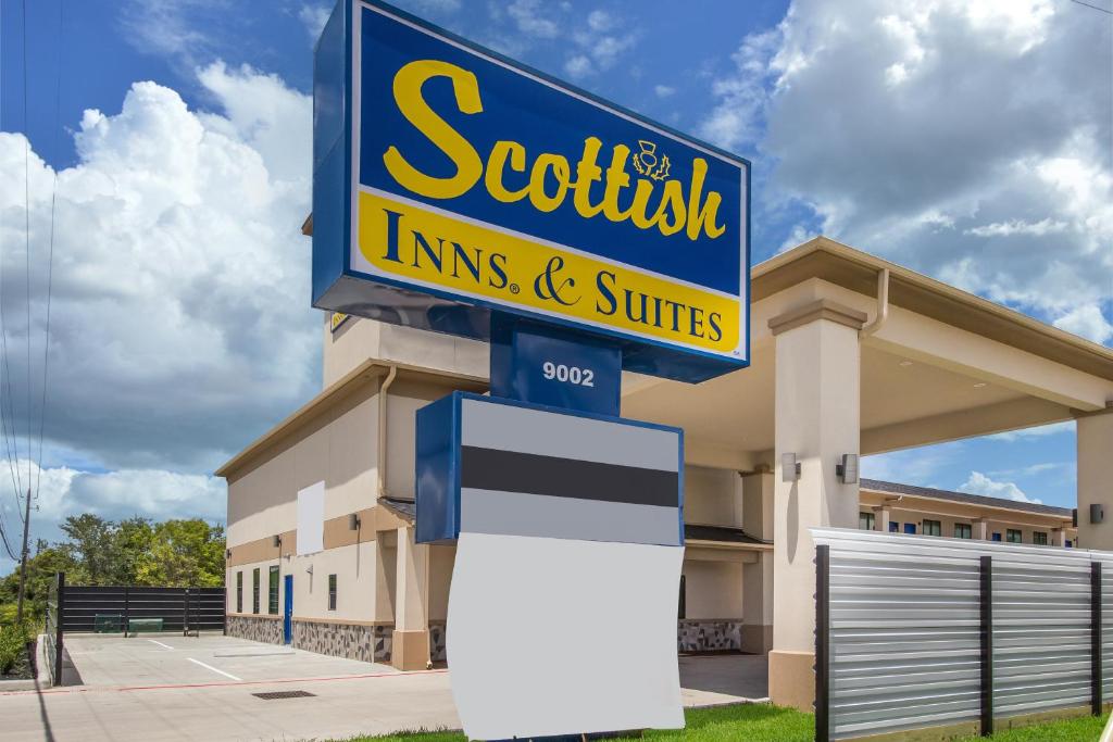 una señal para una tienda frente a un edificio en Scottish Inns & Suites Hitchcock-Santa Fe, en Hitchcock
