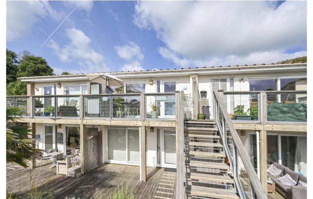 an exterior view of a house with a deck at Stunning Compact Apartment Just Outside Looe in Torpoint