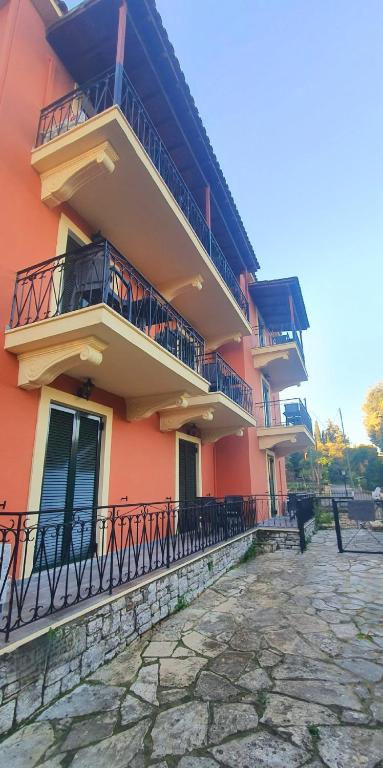 a building with balconies on the side of it at BELLA DE LUX RESIDENCE in Kato Korakiana