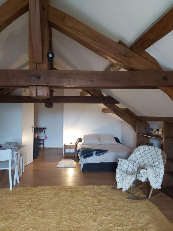 a bedroom with a bed in a attic at Chambre privée +thé et café 