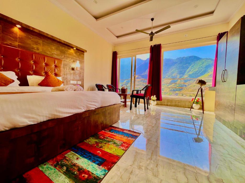 a bedroom with a large bed and a swimming pool at The Kempty Fall Resort, Mussoorie in Mussoorie