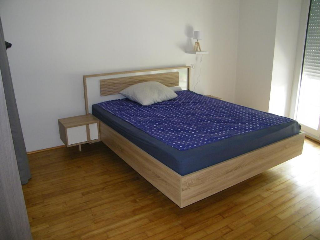 Schlafzimmer mit einem Bett mit blauer Matratze in der Unterkunft Appartement Cransac 2 in Cransac