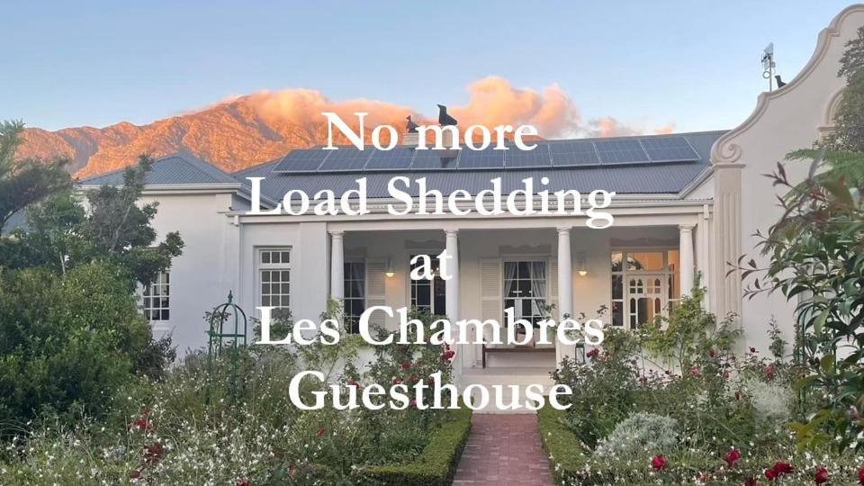 a house with the words no more load shedding less christs guest house at Les Chambres Guest House in Franschhoek