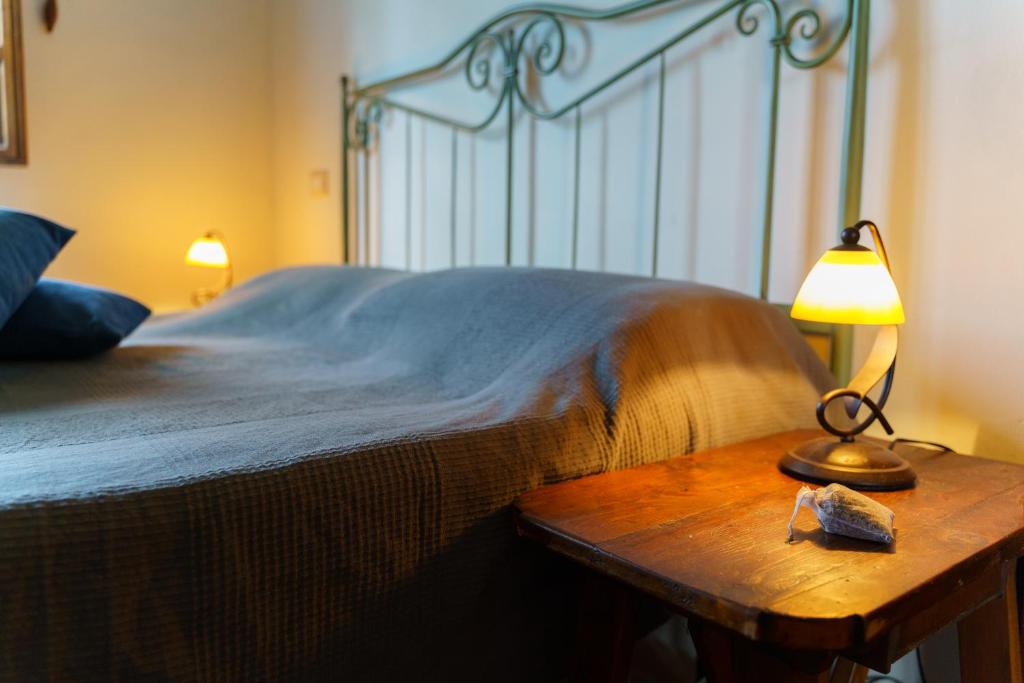 a bedroom with a bed and a table with a lamp at Agriturismo Ca'Mazzetto in Valfabbrica