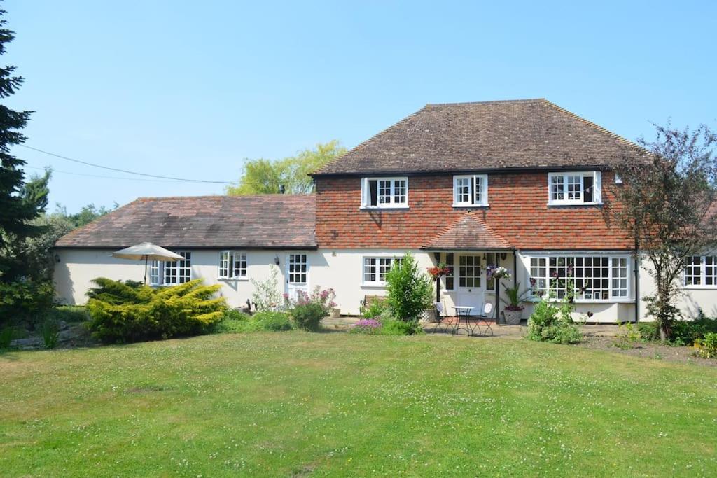 a house with a large lawn in front of it at The Willow Studio - peaceful retreat near Whitstable seaside in Kent