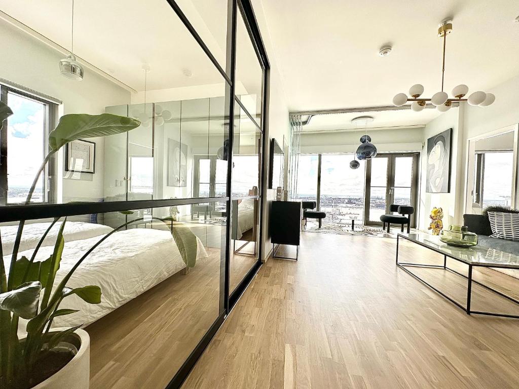 a bedroom with a bed and a glass wall at Luxury Skyscraper Apartment with Amazing view over Helsinki in Helsinki