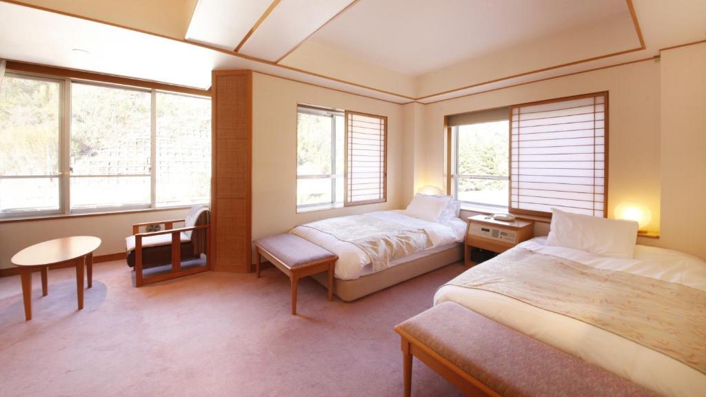 Postel nebo postele na pokoji v ubytování Shimobe Hotel