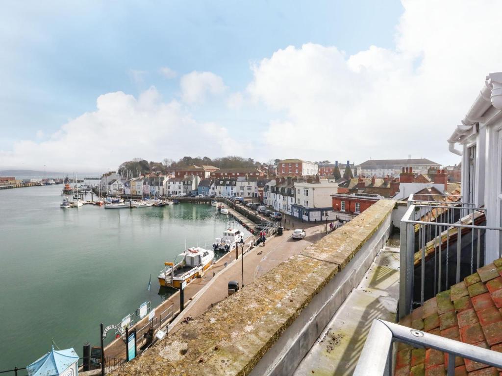 a view of a harbor with boats in the water at Monarch in Weymouth