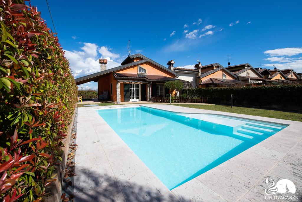 a swimming pool in front of a house at Villa San Martino in San Martino della Battaglia