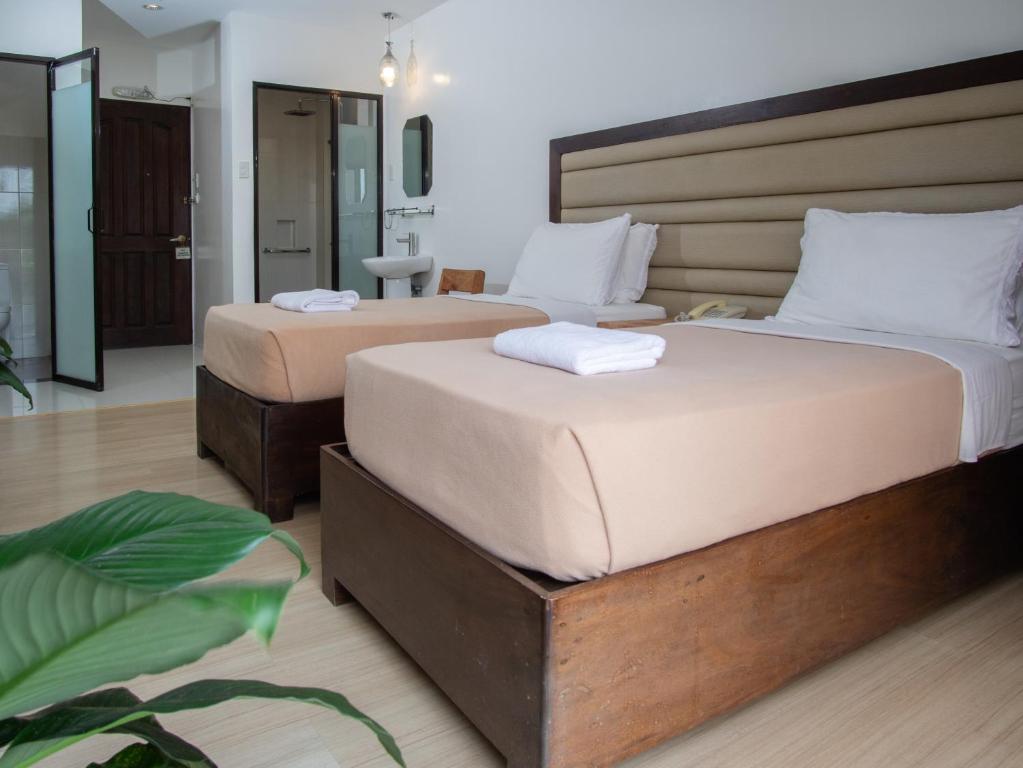 Postel nebo postele na pokoji v ubytování MARZON HOTEL KALIBO