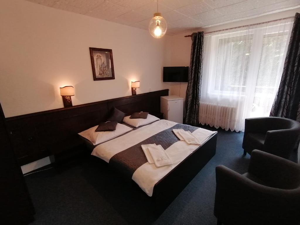 Postel nebo postele na pokoji v ubytování Hotel Pavla Vysočina
