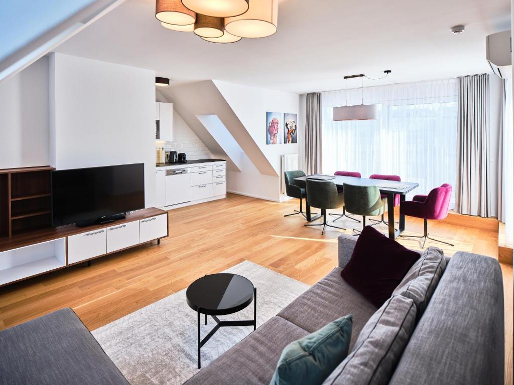 a living room with a couch and a table at MyFavorit by Duschel Apartments Vienna in Vienna