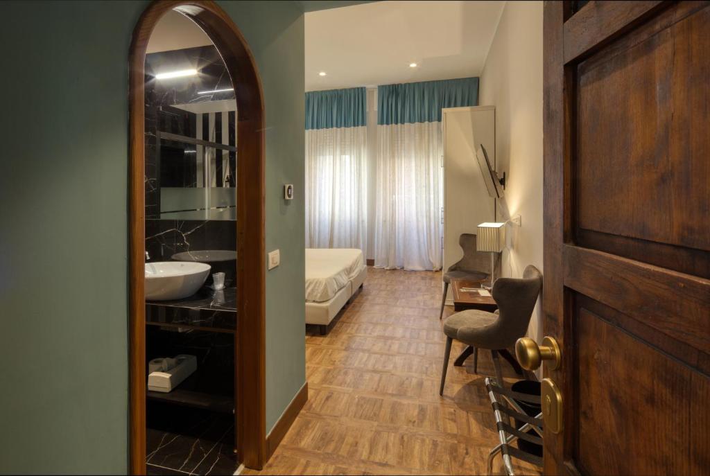 a bathroom with a bed and a sink and a mirror at Hotel Villa Alberti Portofino Land in Santa Margherita Ligure