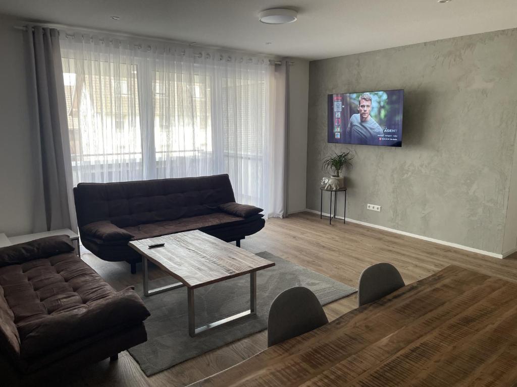 a living room with a couch and a table at Fewo Dani in Rheinhausen