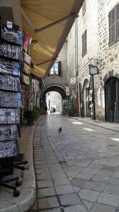 a bird walking down a street in an alley at Little studio in the old town in Vence